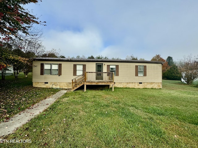 manufactured / mobile home with a front lawn and a deck