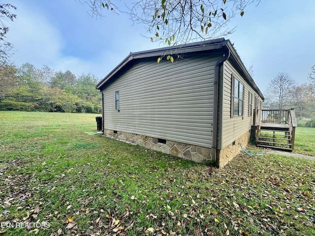 view of home's exterior featuring a yard and a wooden deck