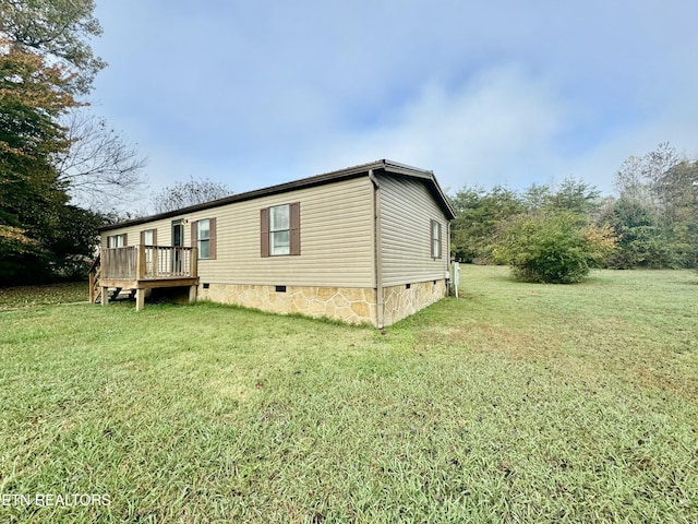 view of home's exterior with a yard and a wooden deck