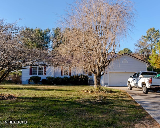 view of front of property featuring a garage and a front lawn