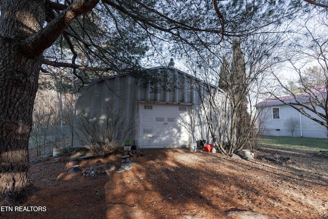 view of home's exterior featuring a garage and an outdoor structure