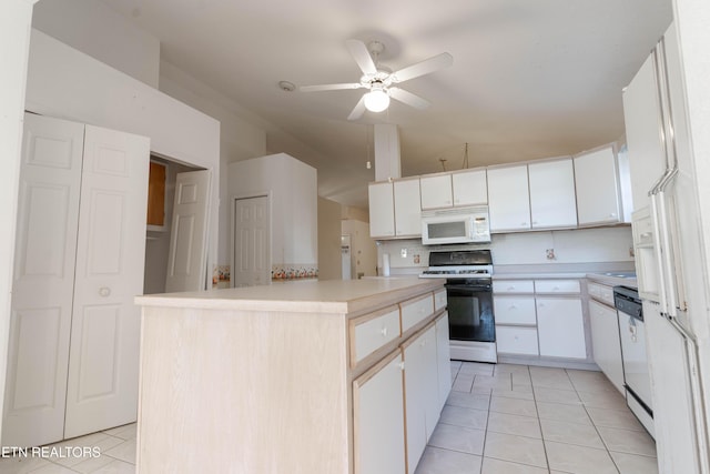 kitchen featuring white appliances, white cabinetry, and a kitchen island