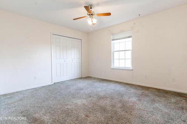 unfurnished bedroom with carpet flooring, a closet, and ceiling fan