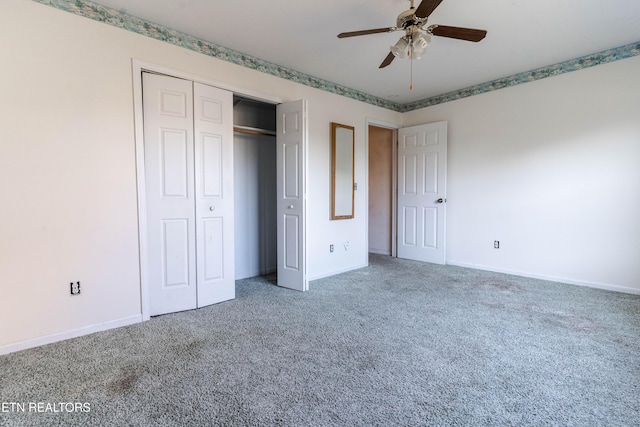 unfurnished bedroom with carpet flooring, ceiling fan, and a closet