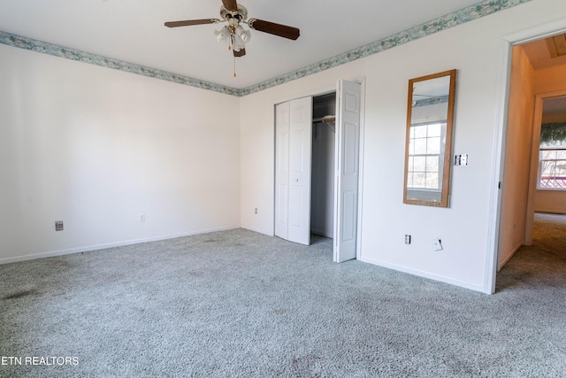 unfurnished bedroom with ceiling fan, a closet, and carpet floors