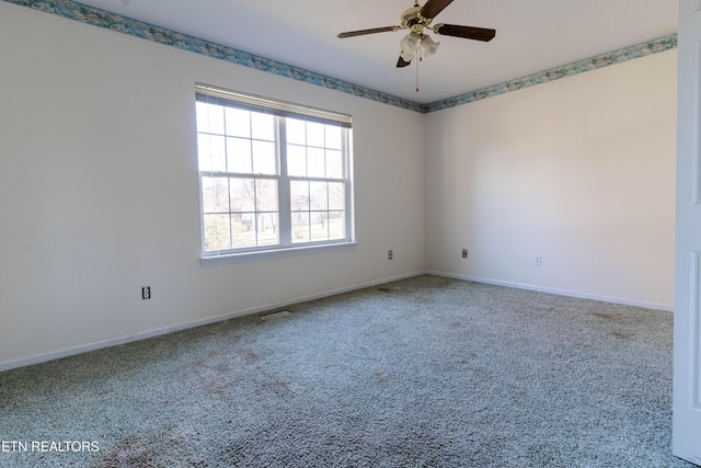 unfurnished room with ceiling fan and carpet floors