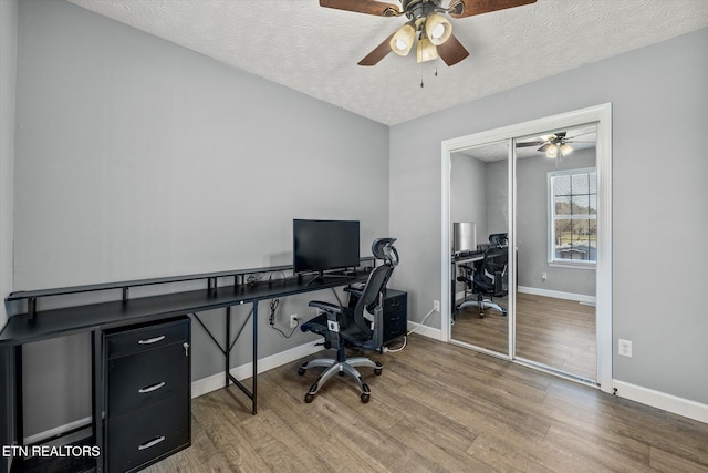 office area featuring a textured ceiling, hardwood / wood-style flooring, and ceiling fan