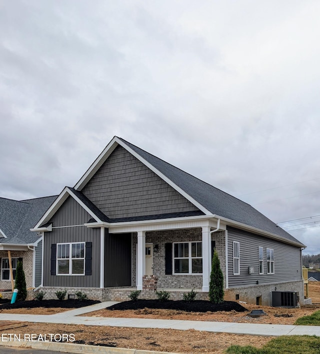 view of front facade featuring cooling unit and a porch