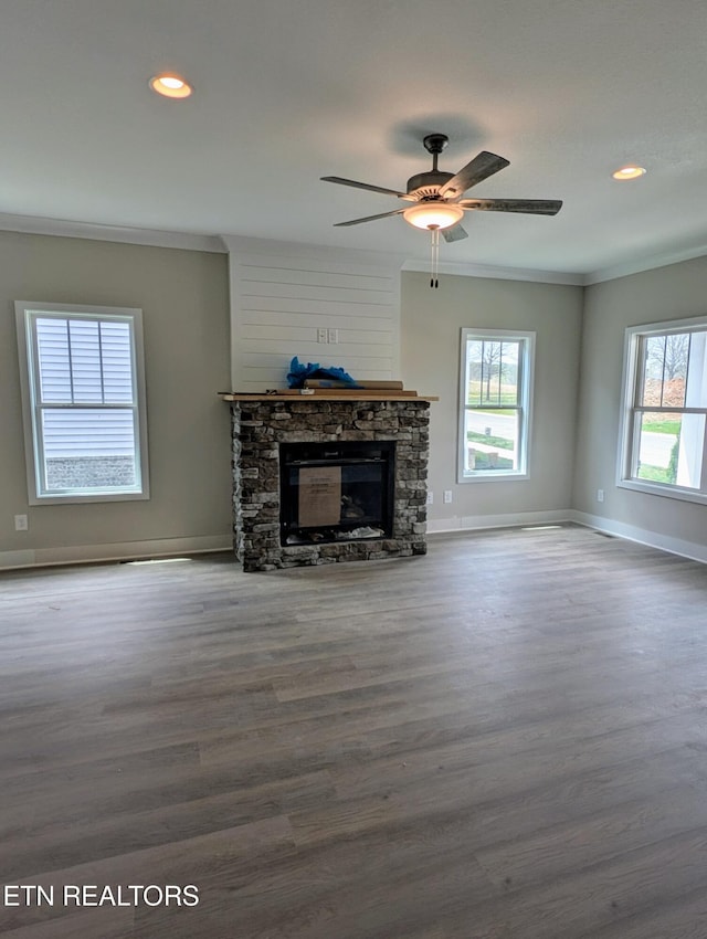 unfurnished living room featuring baseboards, wood finished floors, ornamental molding, and a ceiling fan