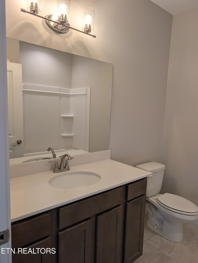 bathroom featuring toilet and vanity