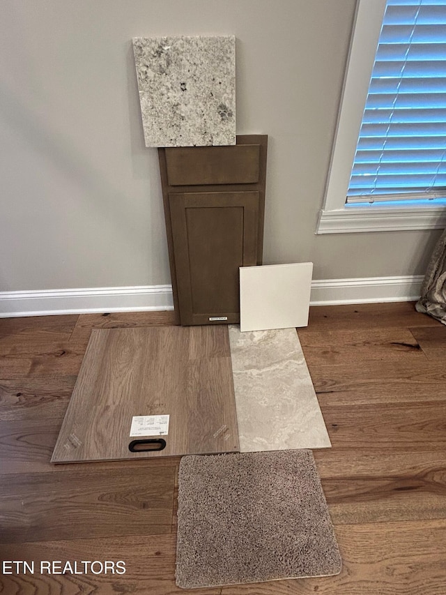 details featuring baseboards and wood finished floors