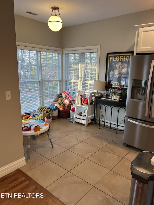 rec room featuring light tile patterned floors and a baseboard radiator