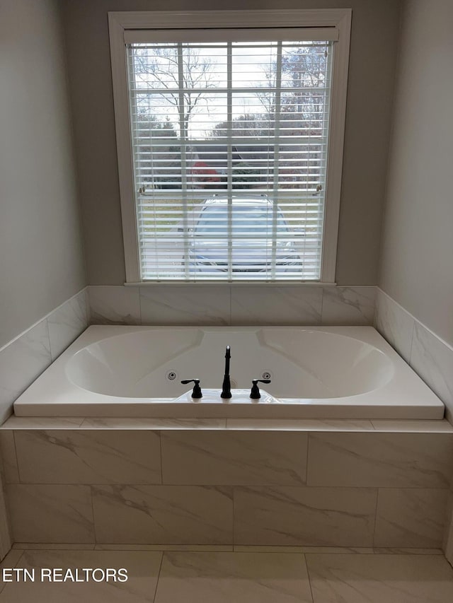 bathroom with tiled bath