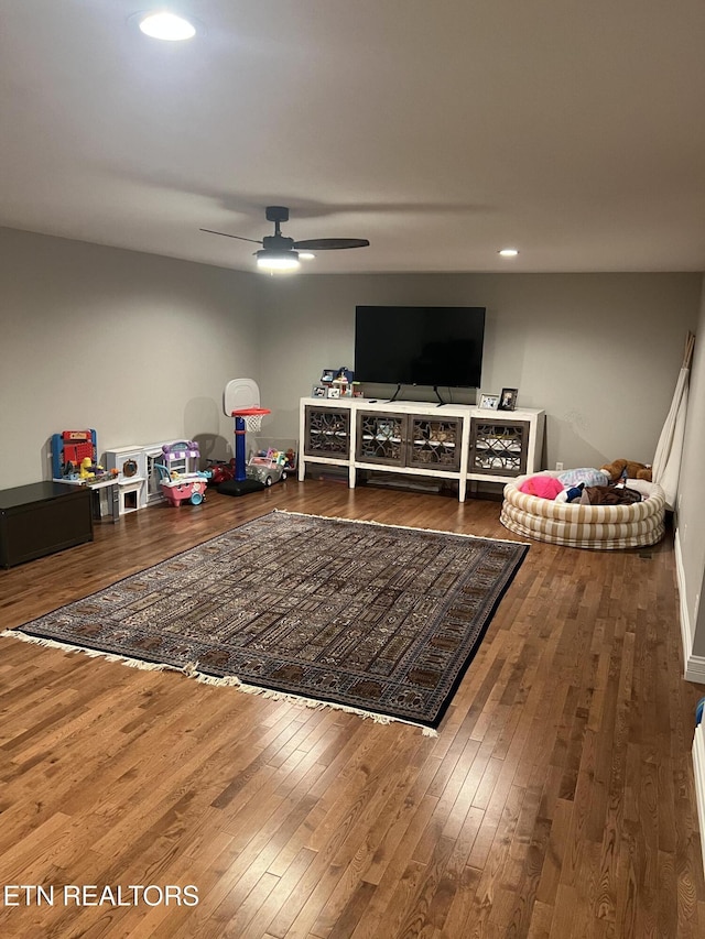 playroom with ceiling fan and hardwood / wood-style floors