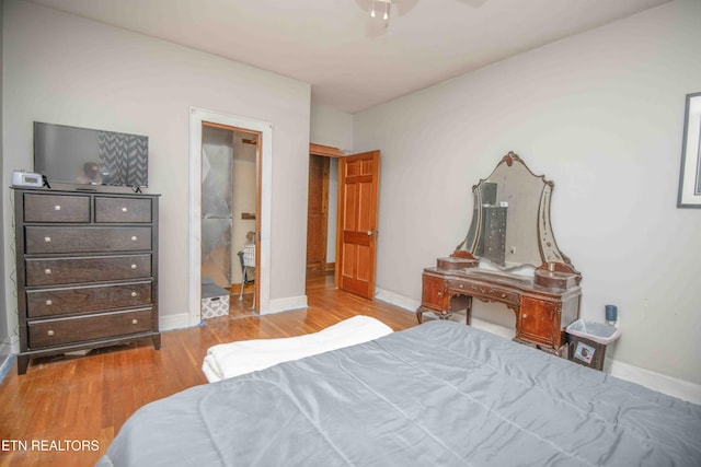 bedroom with light wood-type flooring and ceiling fan