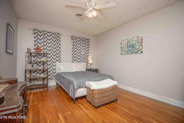 bedroom with hardwood / wood-style floors and ceiling fan