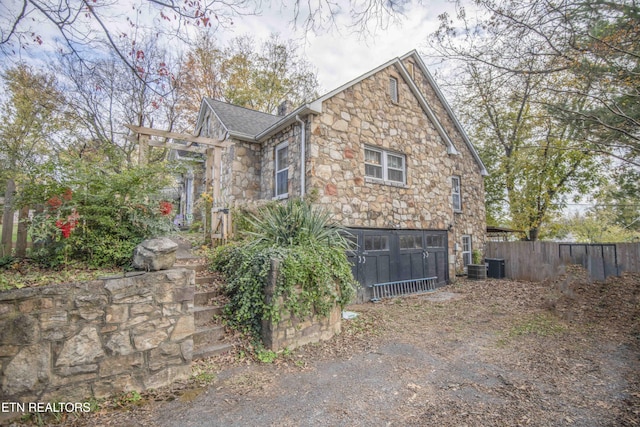 view of side of home featuring central air condition unit