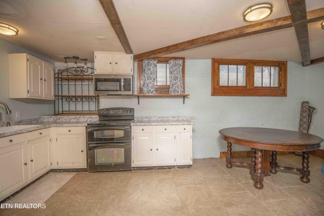 kitchen featuring lofted ceiling with beams, black electric range oven, light tile patterned floors, and sink