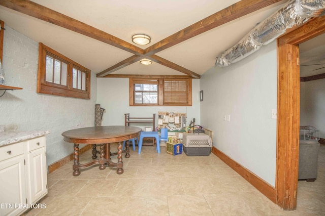 dining area featuring beam ceiling and light tile patterned floors