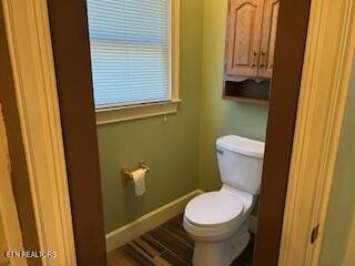 bathroom featuring hardwood / wood-style floors and toilet