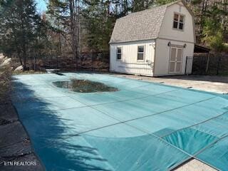 view of swimming pool with an outbuilding