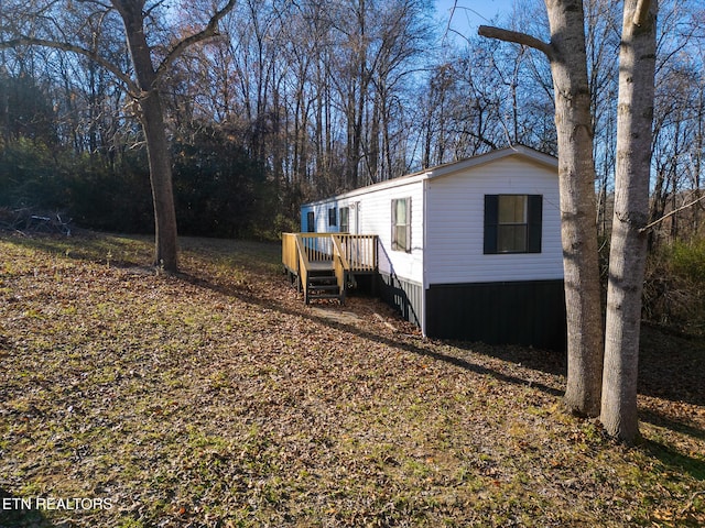 view of property exterior featuring a wooden deck