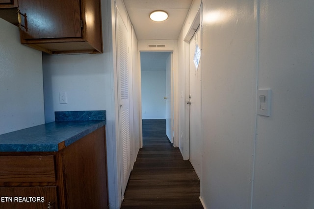 hallway featuring dark wood-type flooring