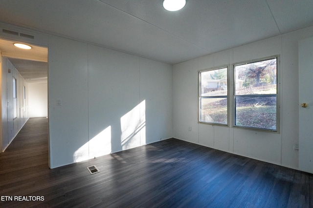 spare room with dark hardwood / wood-style flooring