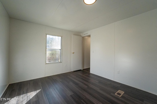 empty room featuring dark wood-type flooring