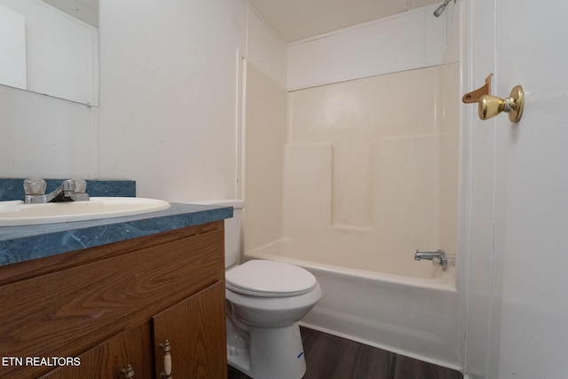 full bathroom featuring toilet, vanity, tub / shower combination, and hardwood / wood-style flooring