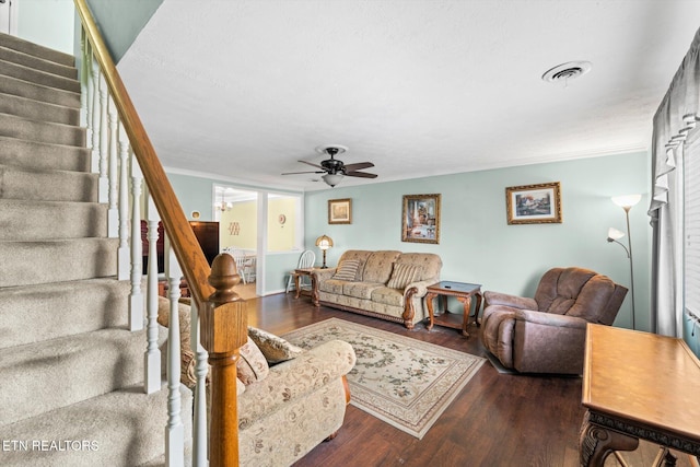 living room featuring dark hardwood / wood-style floors, ceiling fan, and crown molding