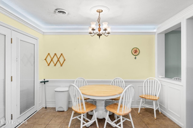 dining room with a chandelier and light tile patterned flooring