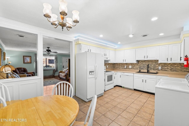 kitchen with sink, crown molding, white appliances, white cabinets, and ceiling fan with notable chandelier