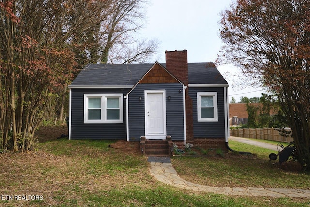 bungalow-style house with a front yard