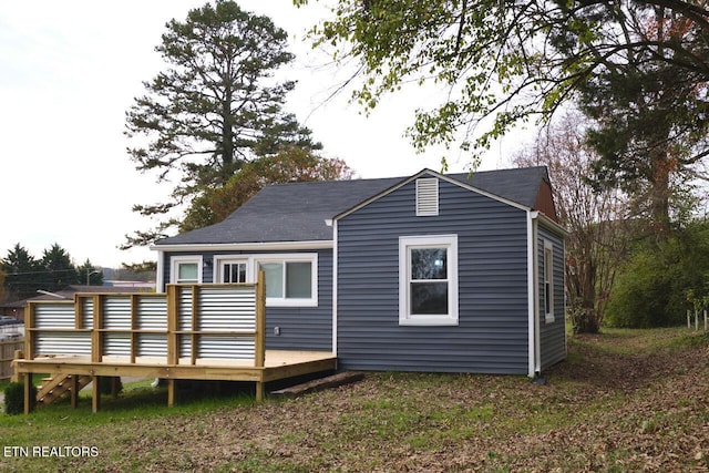 back of house with a wooden deck