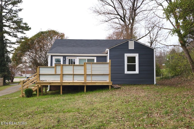 back of house featuring a wooden deck and a yard