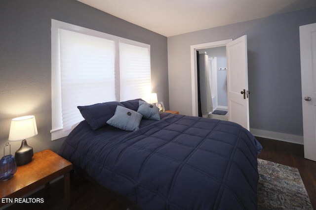 bedroom with dark hardwood / wood-style flooring and multiple windows