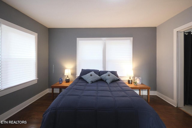 bedroom with dark hardwood / wood-style flooring