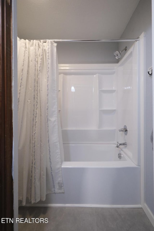 bathroom featuring tile patterned floors and shower / bath combo with shower curtain