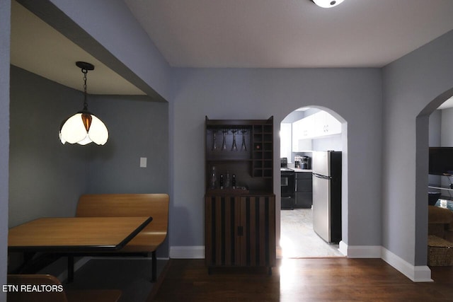 dining room with dark hardwood / wood-style flooring