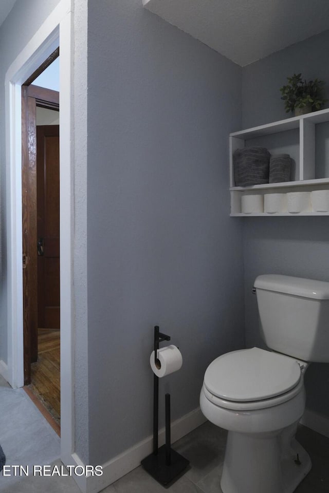 bathroom featuring hardwood / wood-style floors and toilet