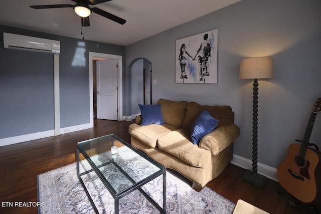 living room with dark hardwood / wood-style floors, a wall unit AC, and ceiling fan