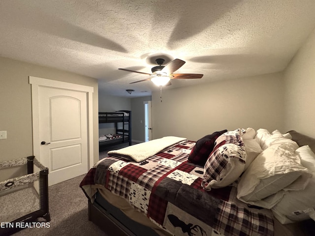 bedroom featuring a textured ceiling, ceiling fan, and dark carpet