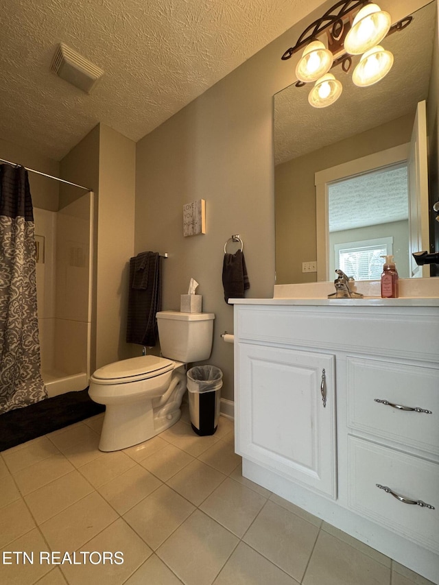 bathroom with toilet, a shower with shower curtain, tile patterned floors, a textured ceiling, and vanity