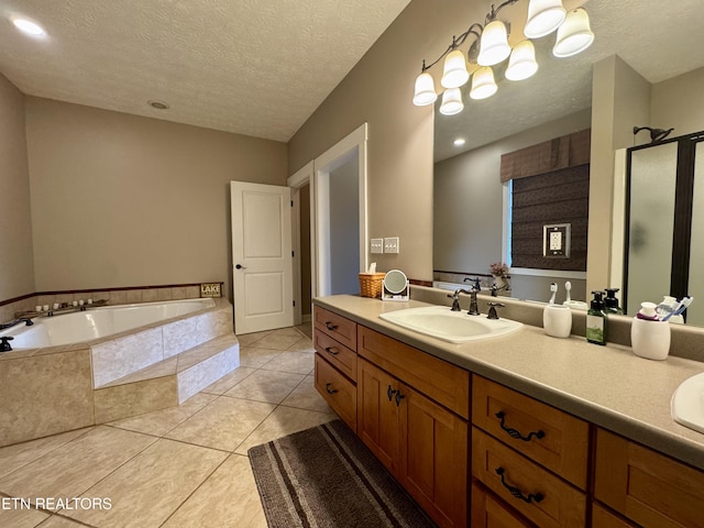 bathroom with a textured ceiling, tile patterned floors, vanity, and independent shower and bath