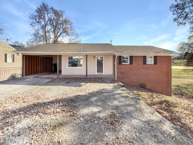 ranch-style house featuring a carport