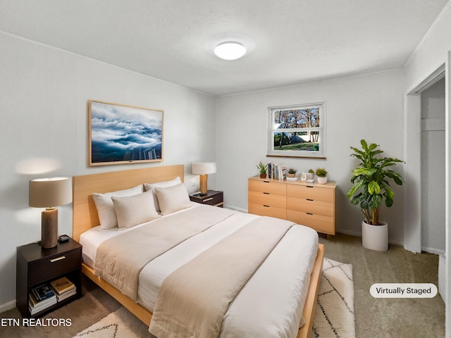 bedroom featuring carpet and a textured ceiling