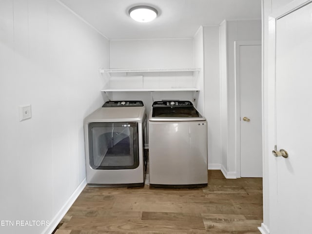 washroom with light hardwood / wood-style floors and independent washer and dryer