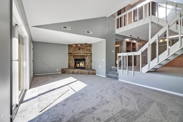 unfurnished living room with carpet floors, a fireplace, and high vaulted ceiling