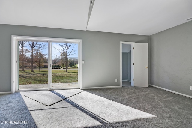 empty room with dark colored carpet